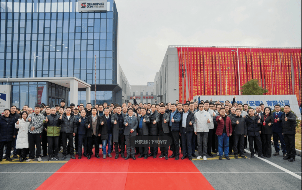 Sane Zenchem Shengxin Rubber full team photo at new smart factory in Xuancheng Anhui, showing large scale manufacturing workforce and unity for custom rubber compounding.