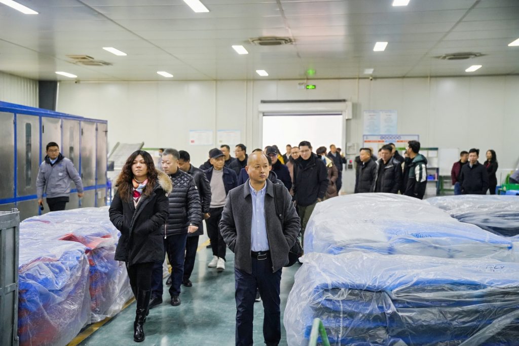 International clients touring automated rubber mixing production line at Sane Zenchem Shengxin Rubber smart plant in Xuancheng China, professional factory visit.