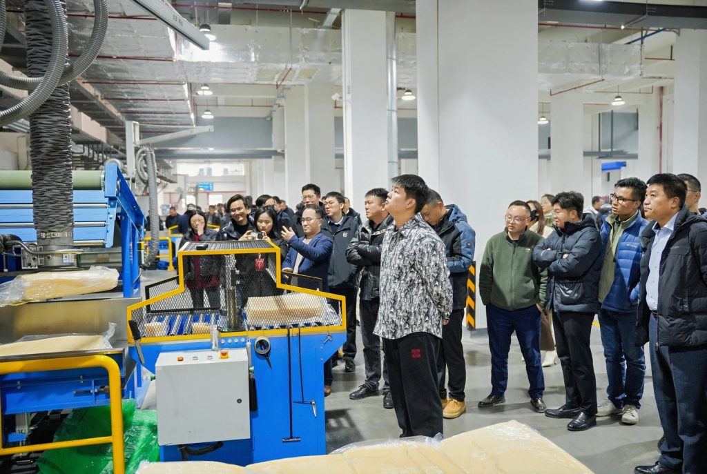International clients touring automated rubber mixing production line at Sane Zenchem Shengxin Rubber smart plant in Xuancheng China, professional factory visit.