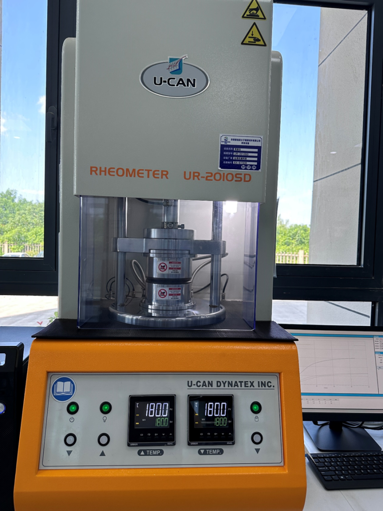 Technician is performing a tensile test and hardness measurement on a sample in a quality control laboratory.