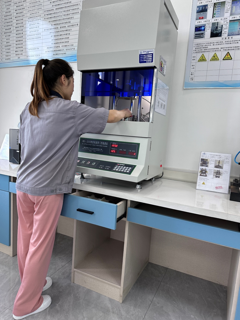 Technician is performing a tensile test and hardness measurement on a sample in a quality control laboratory1.