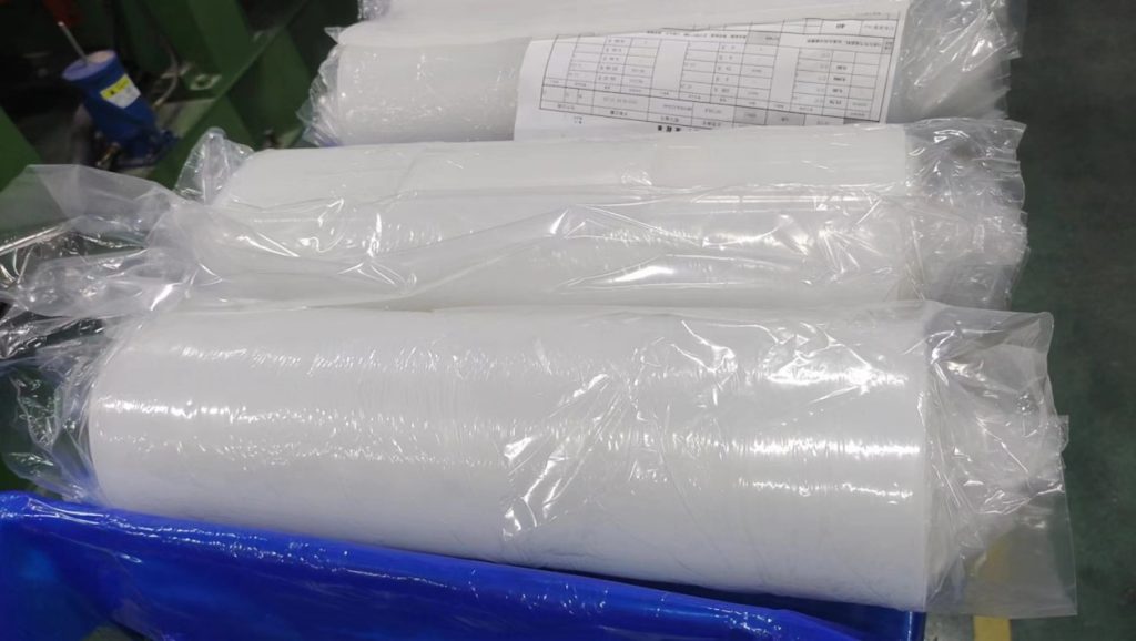 ：  neatly organized warehouse shelves and a sample wall displaying silicone samples in various colors and shapes 